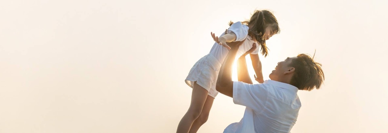 dad carrying his daughter into the air