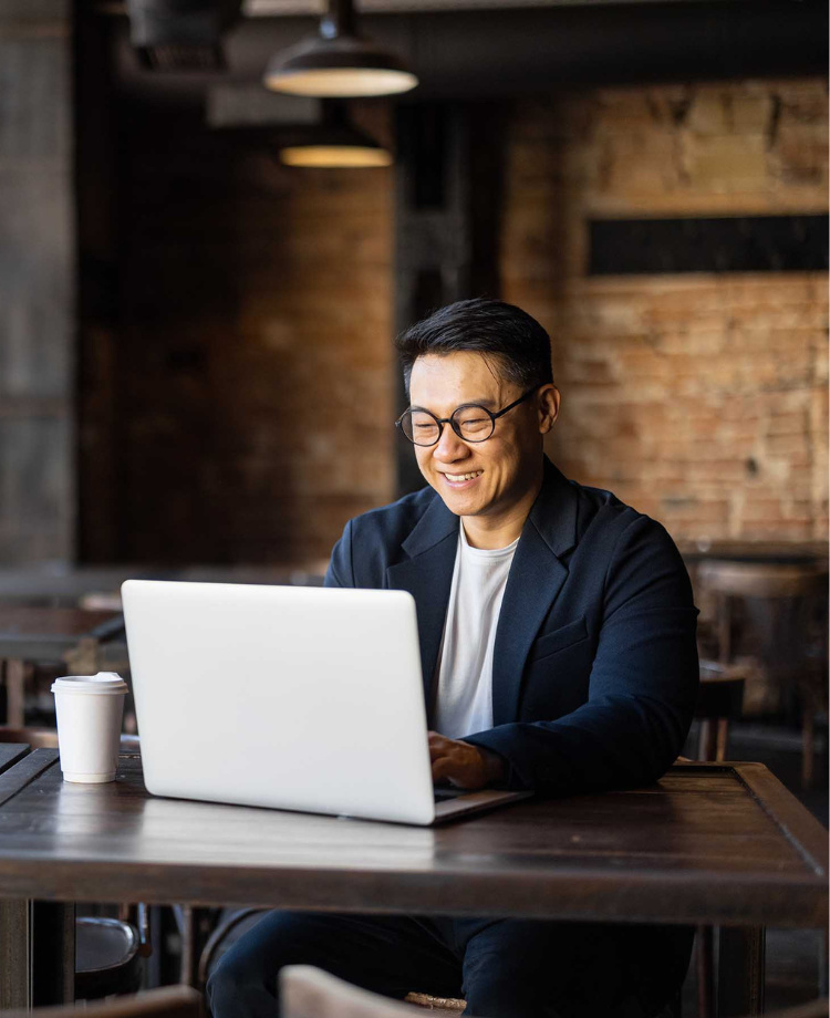 man with glasses sitting in front of laptop